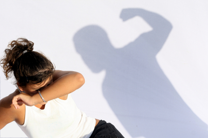 Abused woman in shadow of fist
