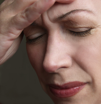 Woman holding head with headache