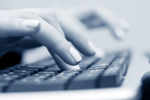 female hands typing on keyboard