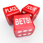 The words Place Your Bets on three red dice to illustrate predic