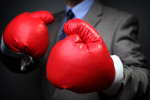 Tough competitive business concept businessman wearing boxing gl