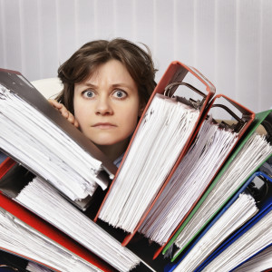 Accountant swamped with financial documents