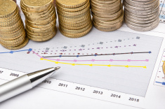 Coins and pen over chart stock photo