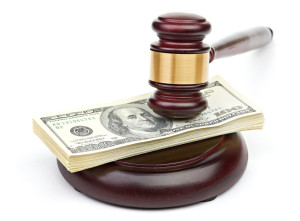 Law gavel on a stack of American money.
