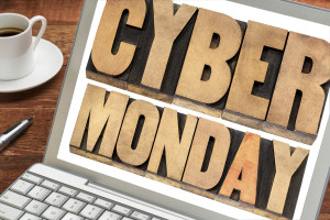 Cyber Monday - online shopping and marketing concept - text in letterpress wood type blocks on a laptop with a cup of coffee