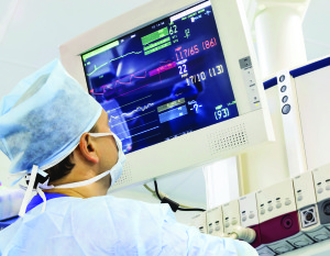 Male anaesthesiologist with monitor