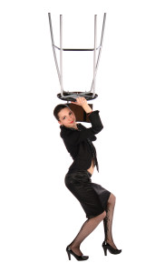 Girl in black suit takes stool up.