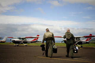 Civil Air Patrol Lt. Col. Wayne Schulz, left, and Capt. John Barringer walk to a C-182 Cessna before departing Astoria, Ore., during Amalgam Dart 2009, June 18, 2009. Amalgam Dart is a field test of the Department of Defense's ability to rapidly deploy an integrated air defense system in the United States. (U.S. Air Force photo by Staff Sgt. Jacob N. Bailey/Released)