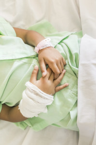 Hands of a Child Swollen and Bandaged Impatient in Hospital