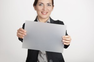 9646044 - beautiful business woman holding a blank translucid paper sheet
