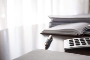 Desk, files, pen, calculator