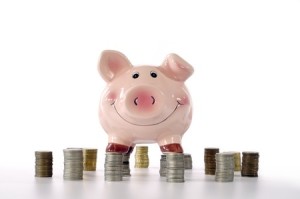 10856566 - pink piggy banks standing on coins