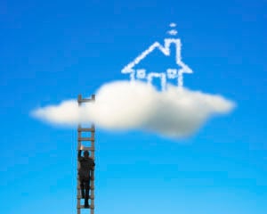 Businessman climbing on wooden ladder to reach cloud house