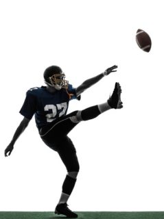 Kicker punting football