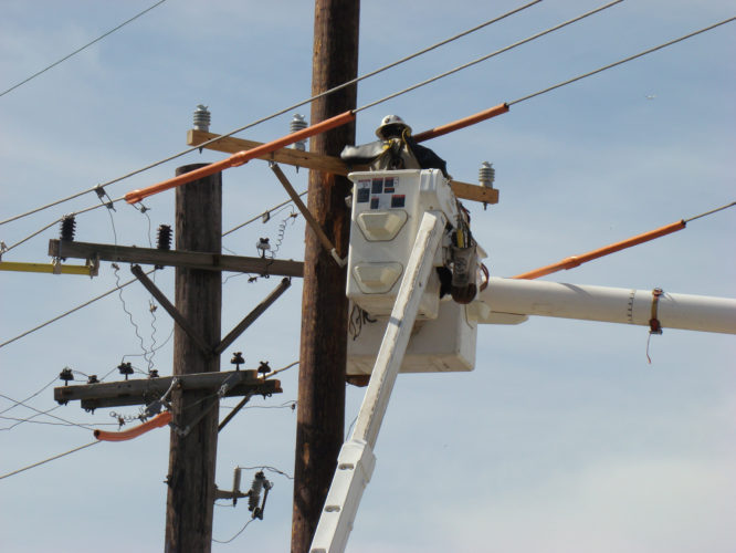 Man on a lift working on the power lines