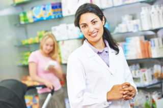 39054530 - portrait of cheerful female pharmacist chemist woman in pharmacy drugstore