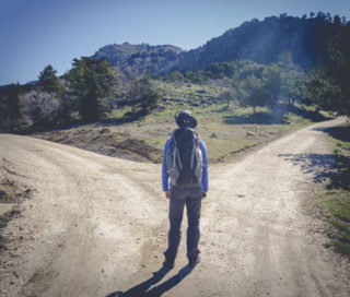 Hiker choosing between to directions at the mountain