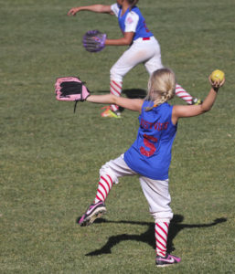 41648699 - summerlin, nevada - june 4: a summerlin little league girls game on june 4, 2015, in summerlin, nevada. two players warm up at a summerlin little league game in summerlin in nevada.