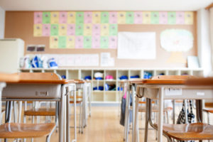 classroom, traditional wooden desks and chairs, pigeon holes