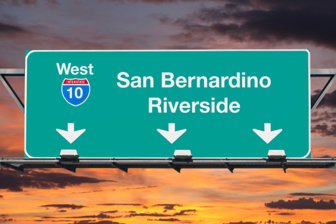 San Bernardino Riverside Interstate 10 west highway sign with sunrise sky.