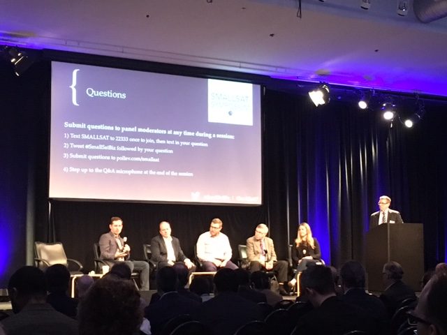 John Booher (Hogan Lovells) moderates a panel on SmallSat constellation management.
