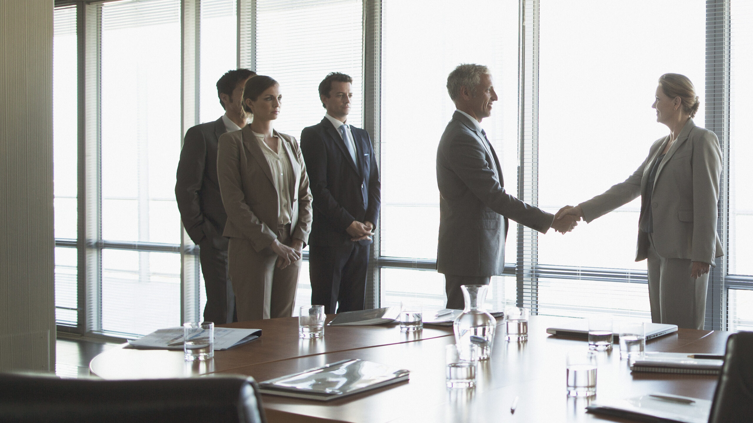 Business people shaking hands in conference room