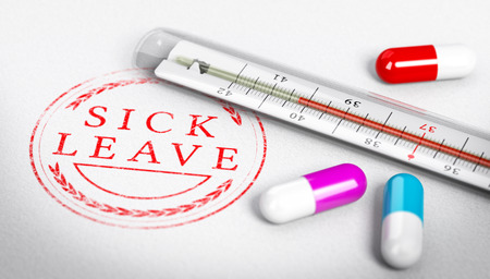 Thermometer and pills on paper marked with Sick Leave label