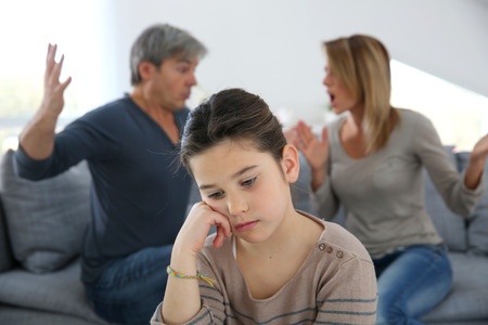 Parents fighting and daughter looking upset