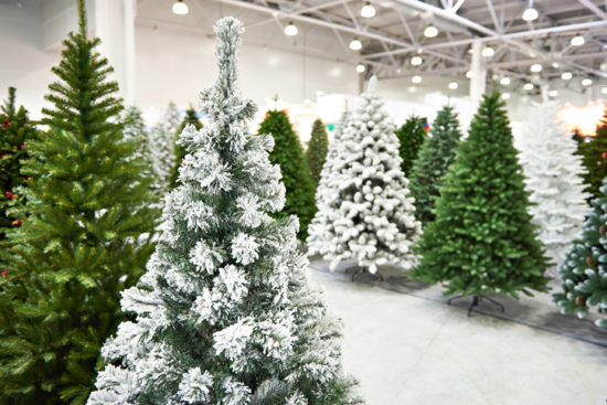 Decorative artificial christmas trees in store