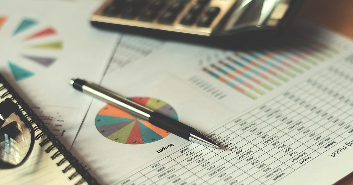 business financial concept with calculator pen and accounting report in office