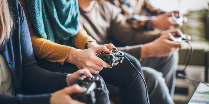 Group of friends playing digital games at home.