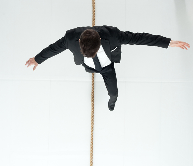 Above view of businessman walking on tightrope