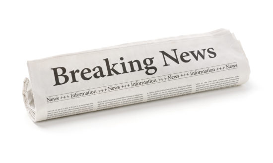 Rolled newspaper with the headline Breaking news