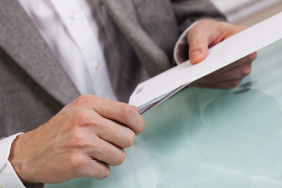 Business person opening an envelope