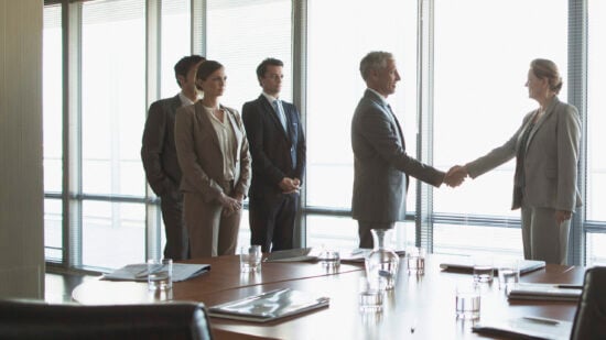 Business people shaking hands in conference room