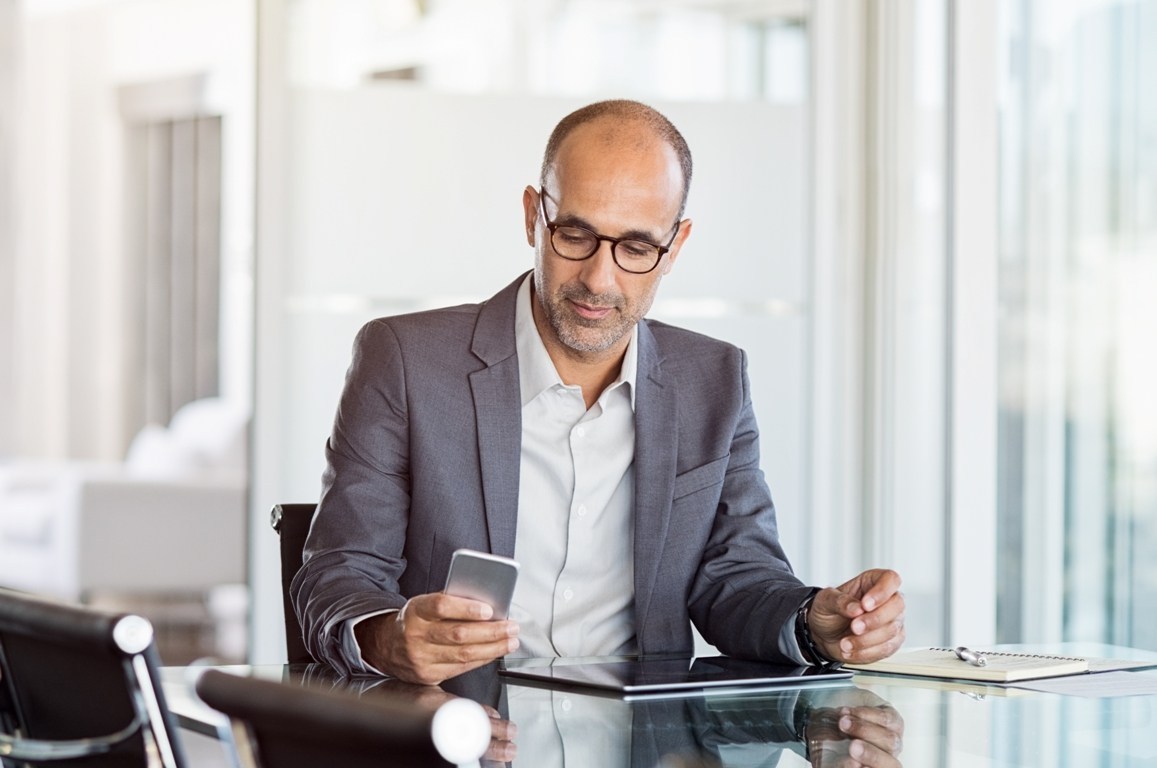 businessman-working-on-phone-PTJA28U.jpg