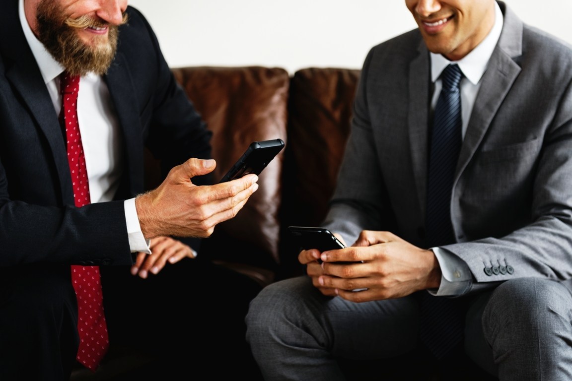 two-businessman-sitting-on-a-couch-PCXMJHK.jpg