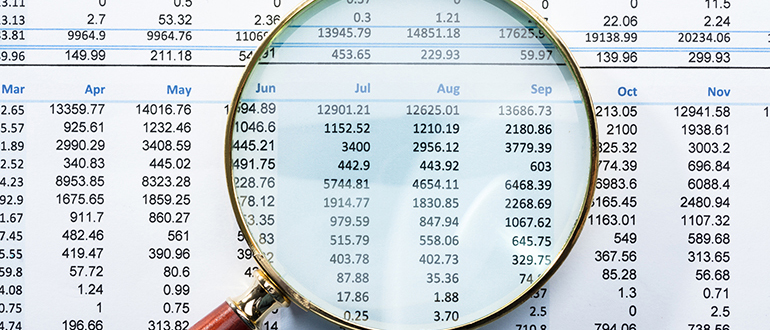 Magnifying Glass On Financial Report
