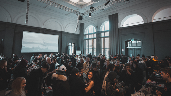 An event room full of people contributing to a fundraiser that benefits a particular not-for-profit.