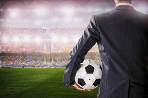 Man in suit at soccer stadium