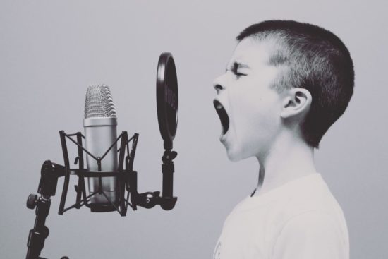 Boy yelling into a microphone