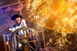 Brave-buccaneer-standing-at-the-helm-of-a-pirate-ship