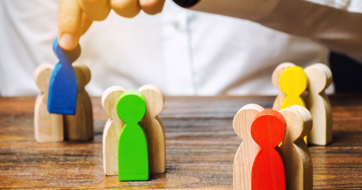 groups-of-multicolored-wooden-people-and-businessman-the-concept-of-picture-id1187138898