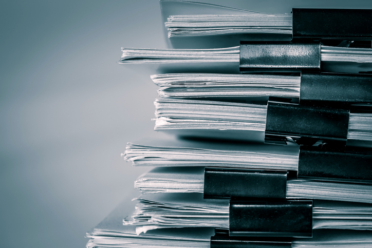 extreamely close up a  report paper stacking of office working document , retro color tone