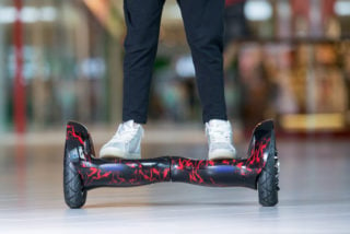 Girl feet on the hover board. Self-balancing scooter or mini segway