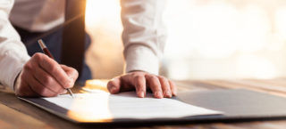Businessman Signing An Official Document as a DBA