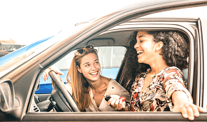 two teenagers talking while driving