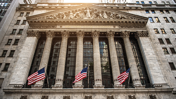 frontal view of a stone building with pillars and American flags; image used for blog post about SEC Chairman Public Statement