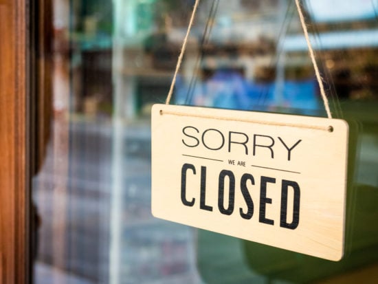 Sorry we are closed sign board hanging on door of cafe