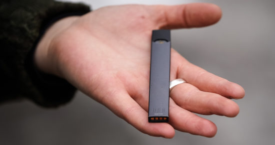 Woman holding Juul e-cig